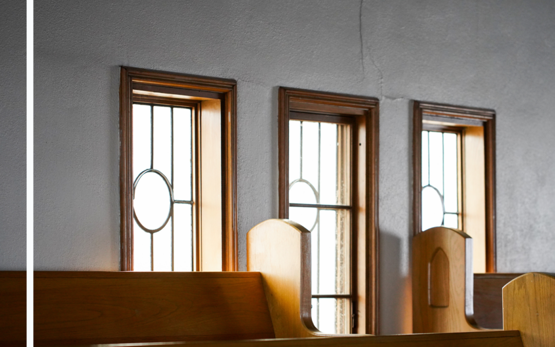 Wooden pews and tall windows inside Platt Park Church sanctuary in Denver